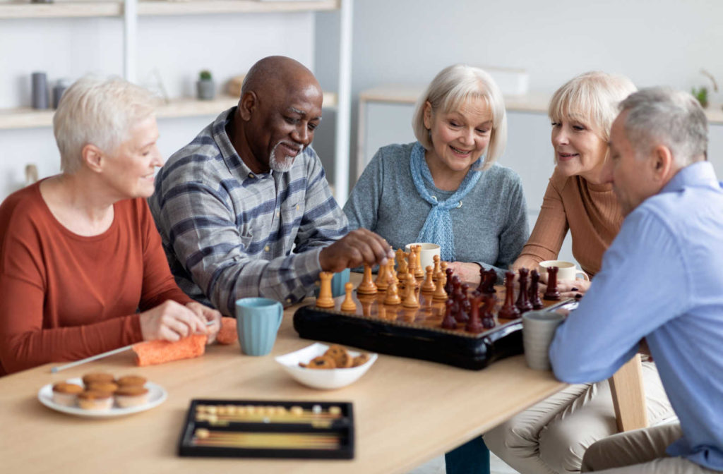 A group of seniors playing chess and backgammon.