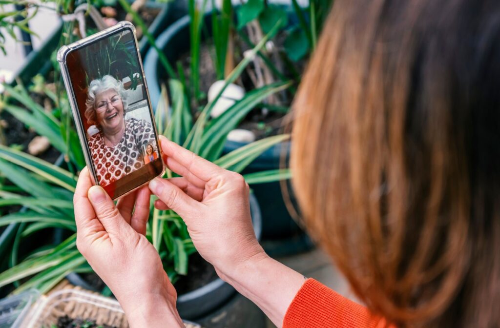 A woman calls her senior parent on video call.