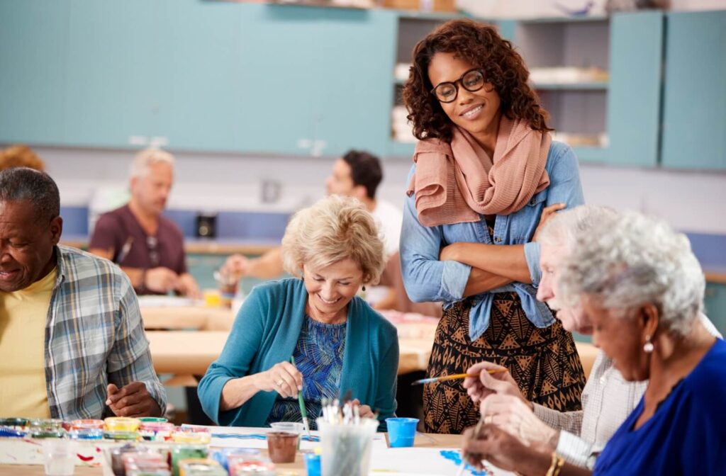 A group of seniors follow an art teacher’s guidance during a painting class to learn new skills and improve mental health