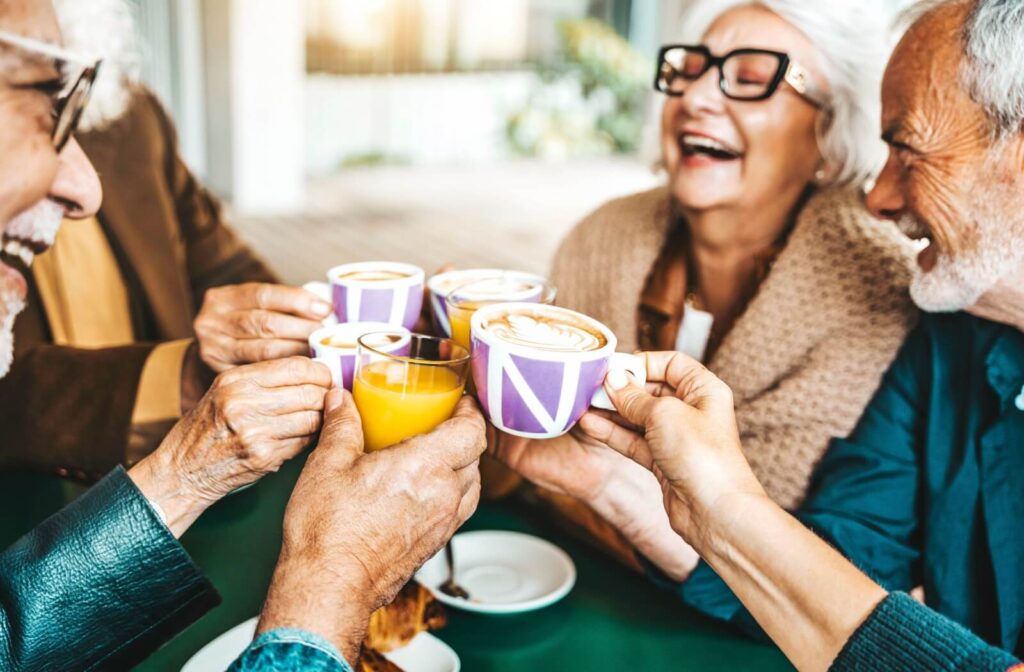 a group of seniors enjoying their hot drinks in holiday breakfast in senior living